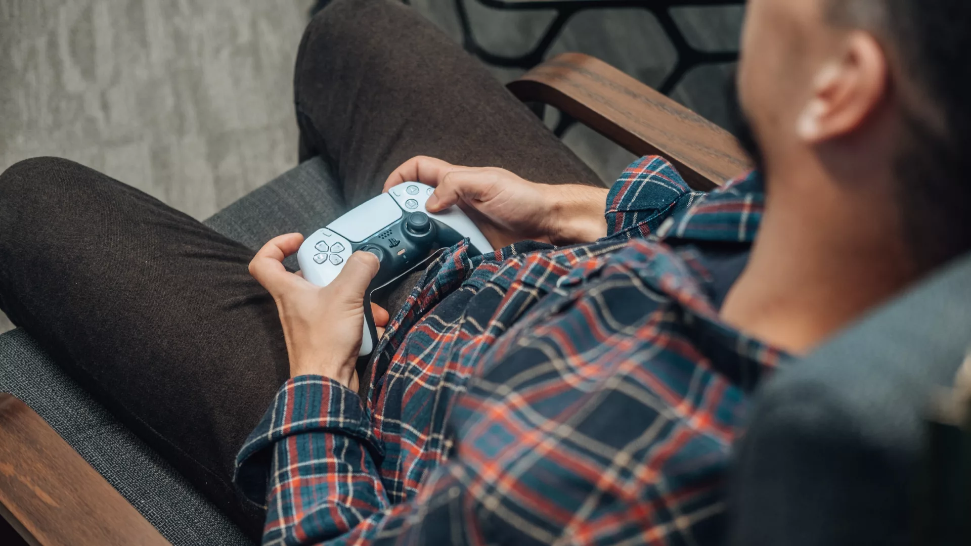 A man on a break at work holding a joystick and playing