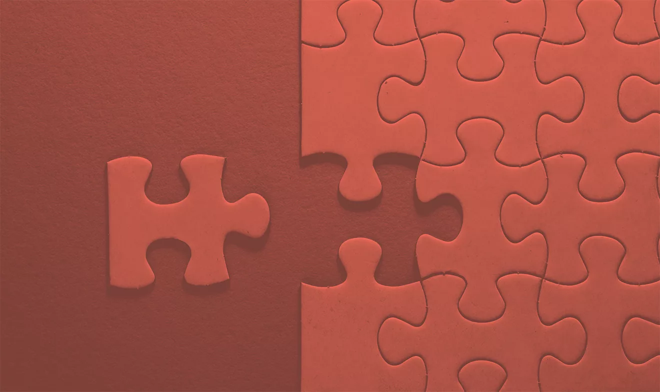 red puzzle with one missing piece