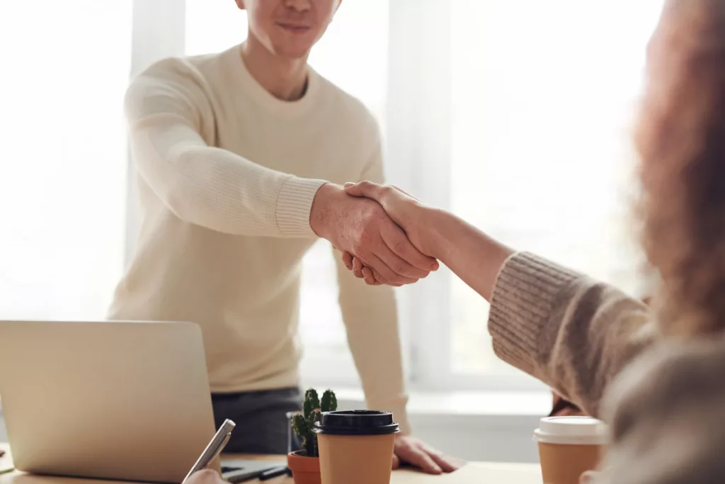 people shaking hands in the office, striking a deal