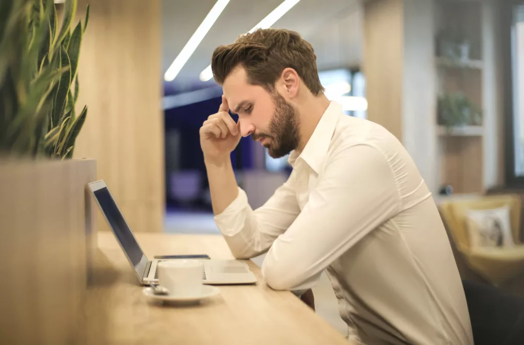 man sitting in an office worried