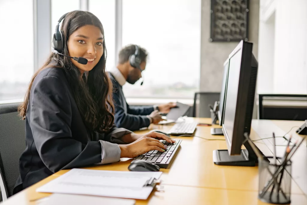 A person smiling and sitting in an office