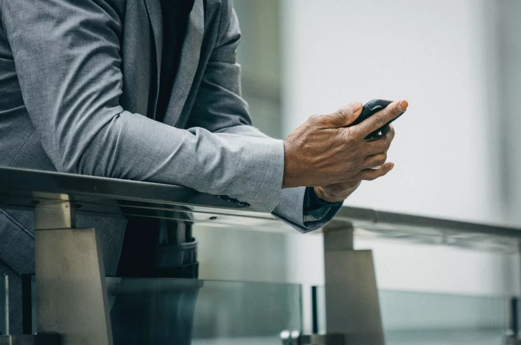 A person in a suit looking at their phone