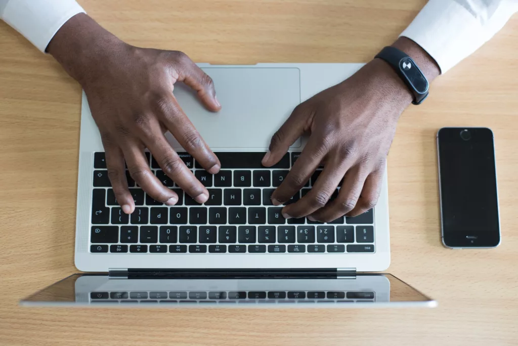 a person typing on a laptop